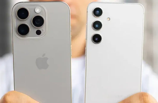 image of iphone and samsung in a hand for comparision